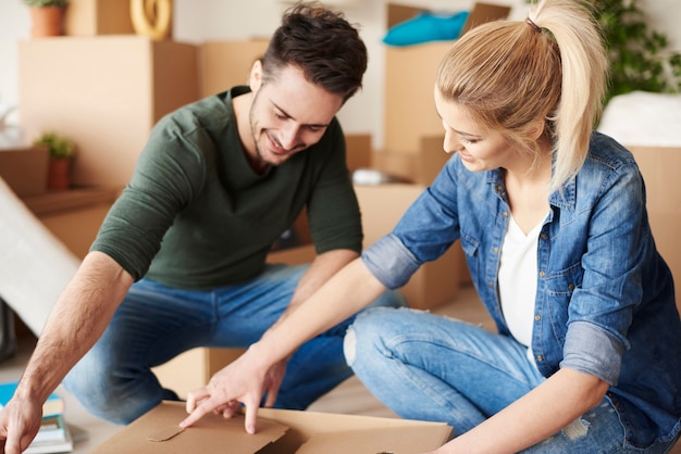 Couple unpacking cartons in new home