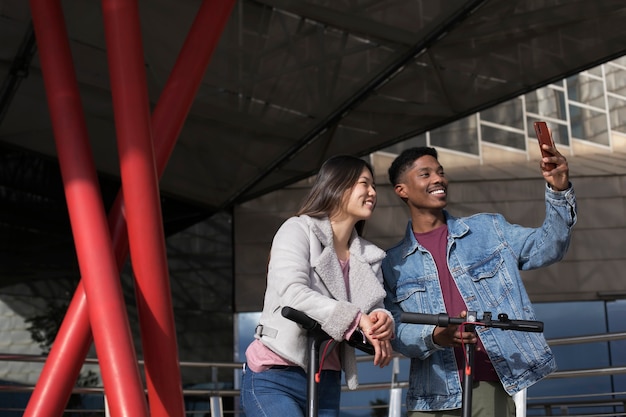 Couple using electric scooter for transportation