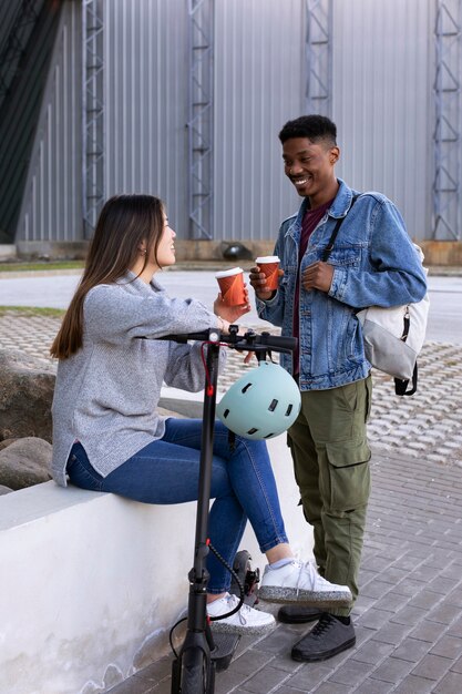 Couple using electric scooter for transportation