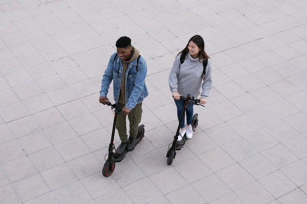 Couple using electric scooter for transportation