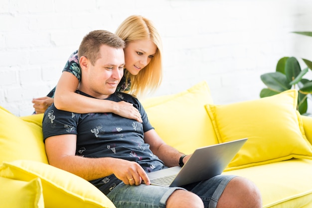 Couple using laptop in living room