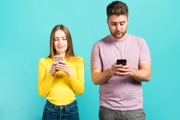 Couple using their mobile phones