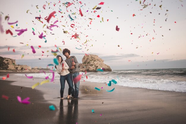 Couple using two confetti cannons