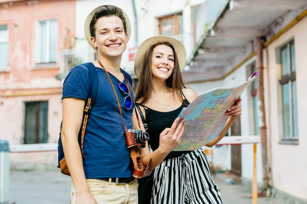 Free photo couple on vacation in city with map