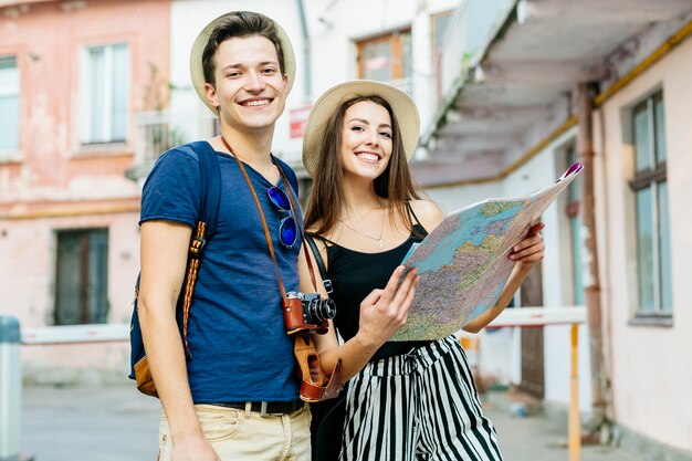 Couple on vacation in city with map