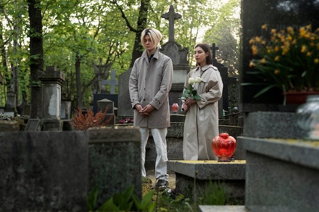 Couple visiting a grave together at the cemetery