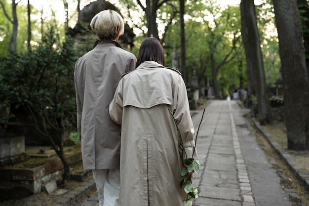 couple visiting a grave together at the cemetery