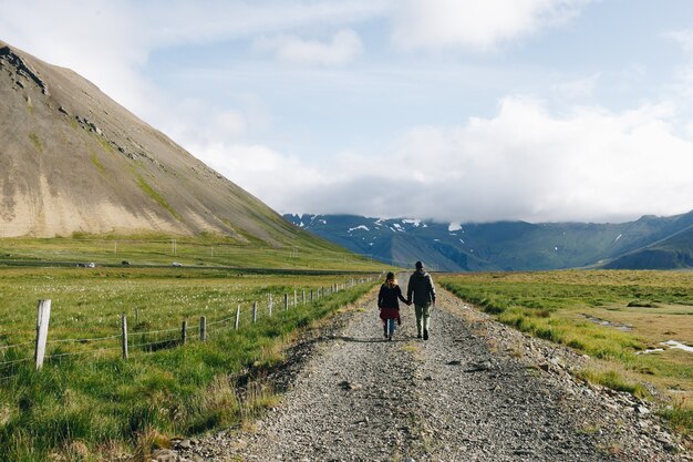 Couple walk on rural country gravel road