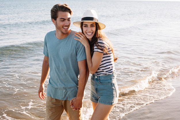 Free photo couple walking at the beach