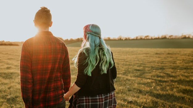 Couple walking and holding hands outdoors