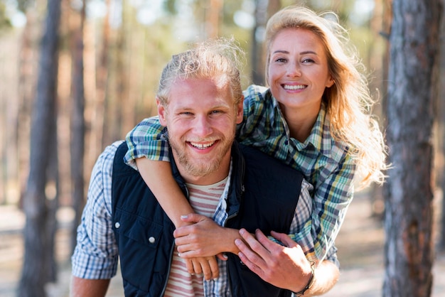 Couple walking in the woods front view