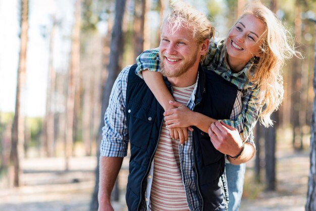 Couple walking in the woods medium shot