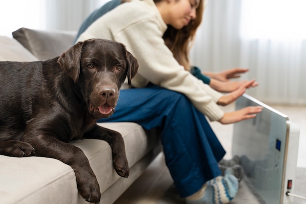 Couple warming up with heater at home