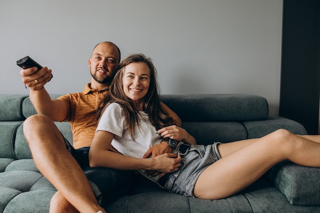 Free photo couple watch tv in a living room