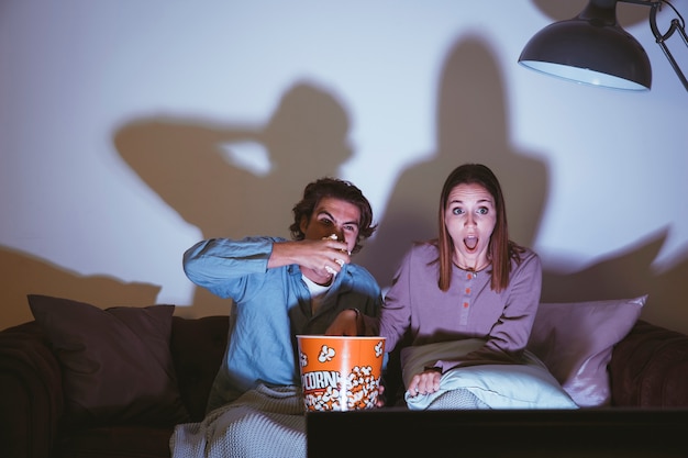 Free photo couple watching a scary movie