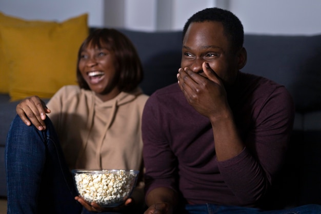 Couple watching streaming service together at home indoors