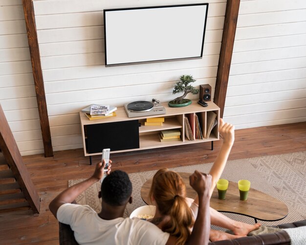 Couple watching streaming service together in the living room