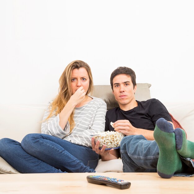 Couple watching television at home
