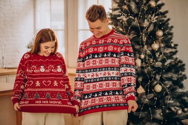 Free photo couple wearing christmas sweaters together