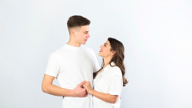 Couple in white holding hands 