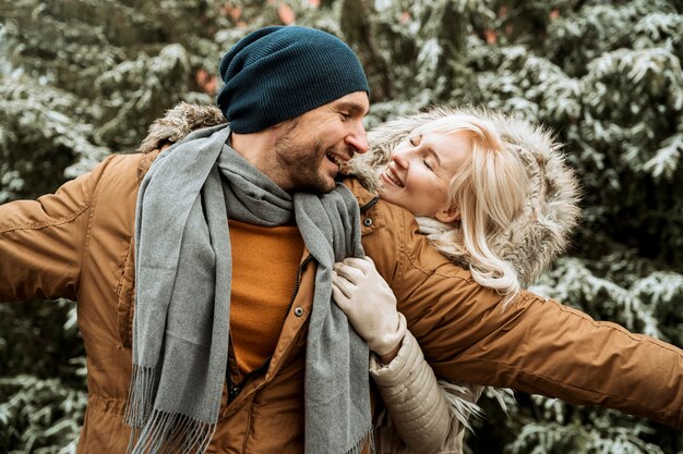 Couple in winter being happy and fooling around