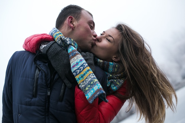 Free photo couple in winter forest near lake