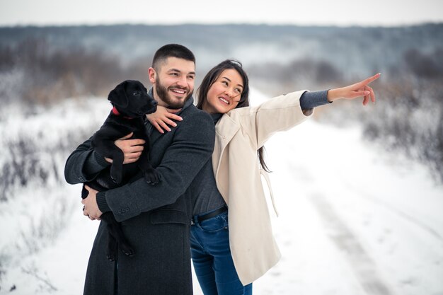 Couple in winter in the street with dog