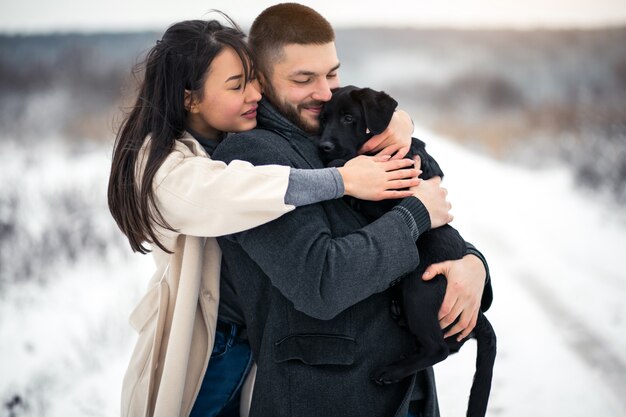 Couple in winter in the street with dog