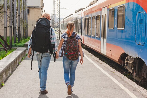Couple with backpack at train station