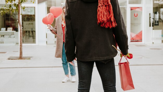 Couple with balloons and paper bag