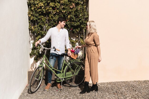 Couple with bicycle enjoying a walk