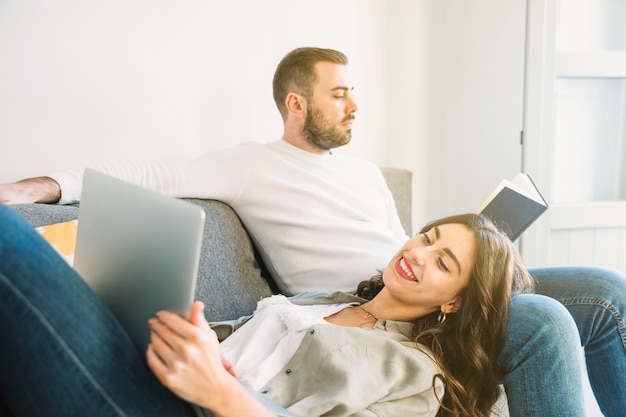 Free photo couple with book and laptop resting