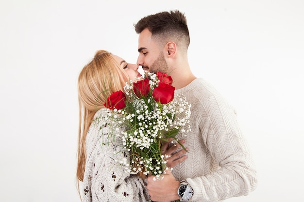 Free photo couple with bouquet touching noses