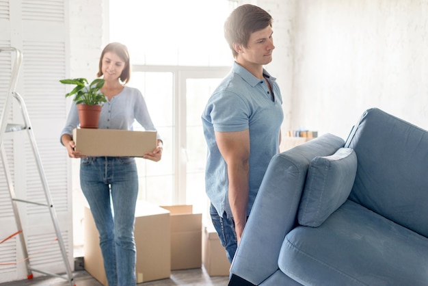 Couple with boxes and couch preparing to move out