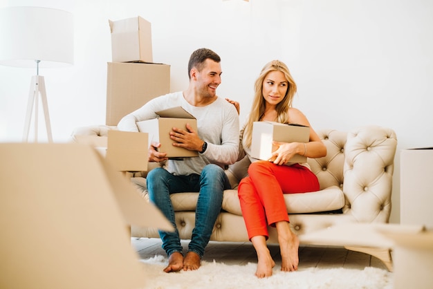 Free photo couple with boxes relocating