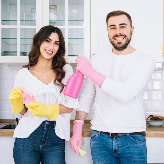 Couple with cleaning equipment