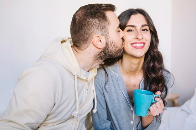 Couple with cup kissing
