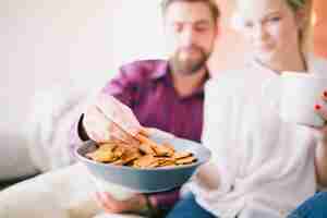 Free photo couple with cups and cookies