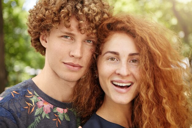 couple with curly red hair relaxing outdoors
