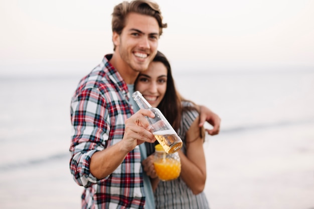 Couple with drink at the beach