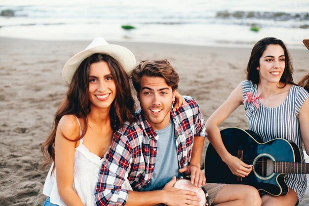 Couple with friends at the beach