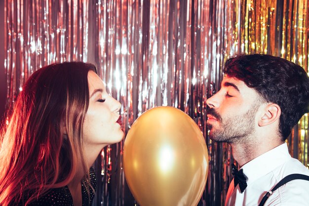 Couple with golden balloon