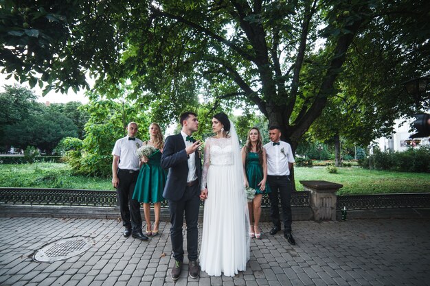 Couple with guests posing on street