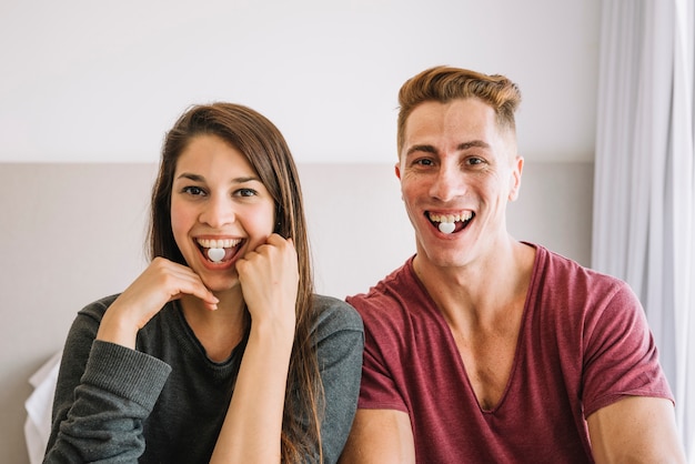 Free photo couple with heart candies in mouth