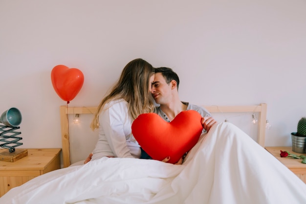 Free photo couple with heart cuddling