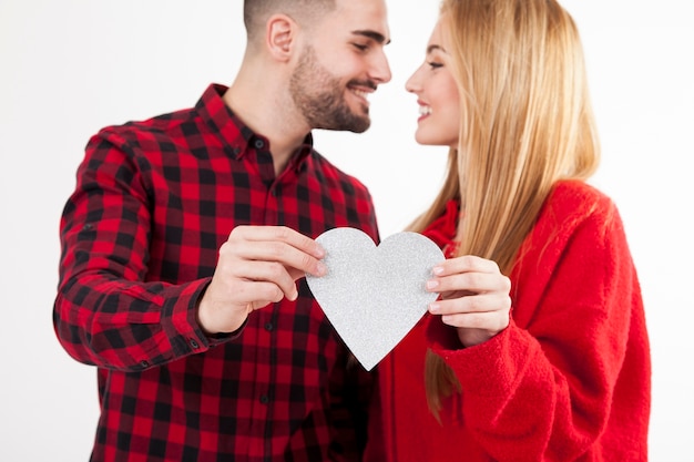 Free photo couple with heart looking at each other