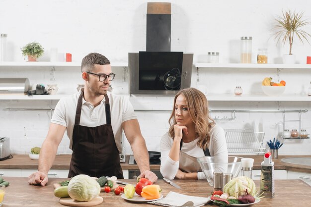 Couple with ingredientes in kitchen