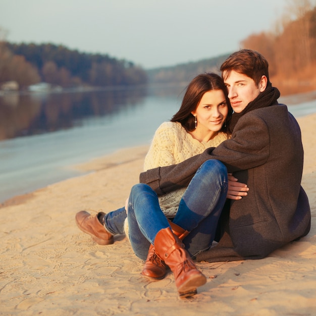 Couple with jeans sitting on the ground