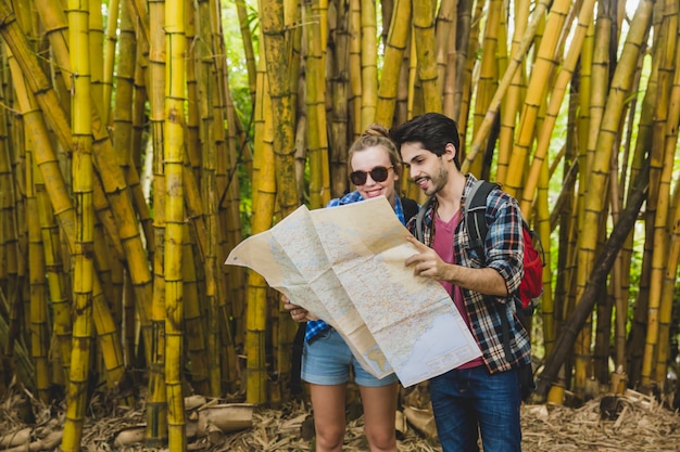 Couple with map in bamboo forest