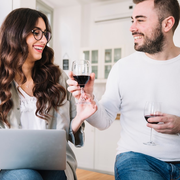 Free photo couple with notebook having wine